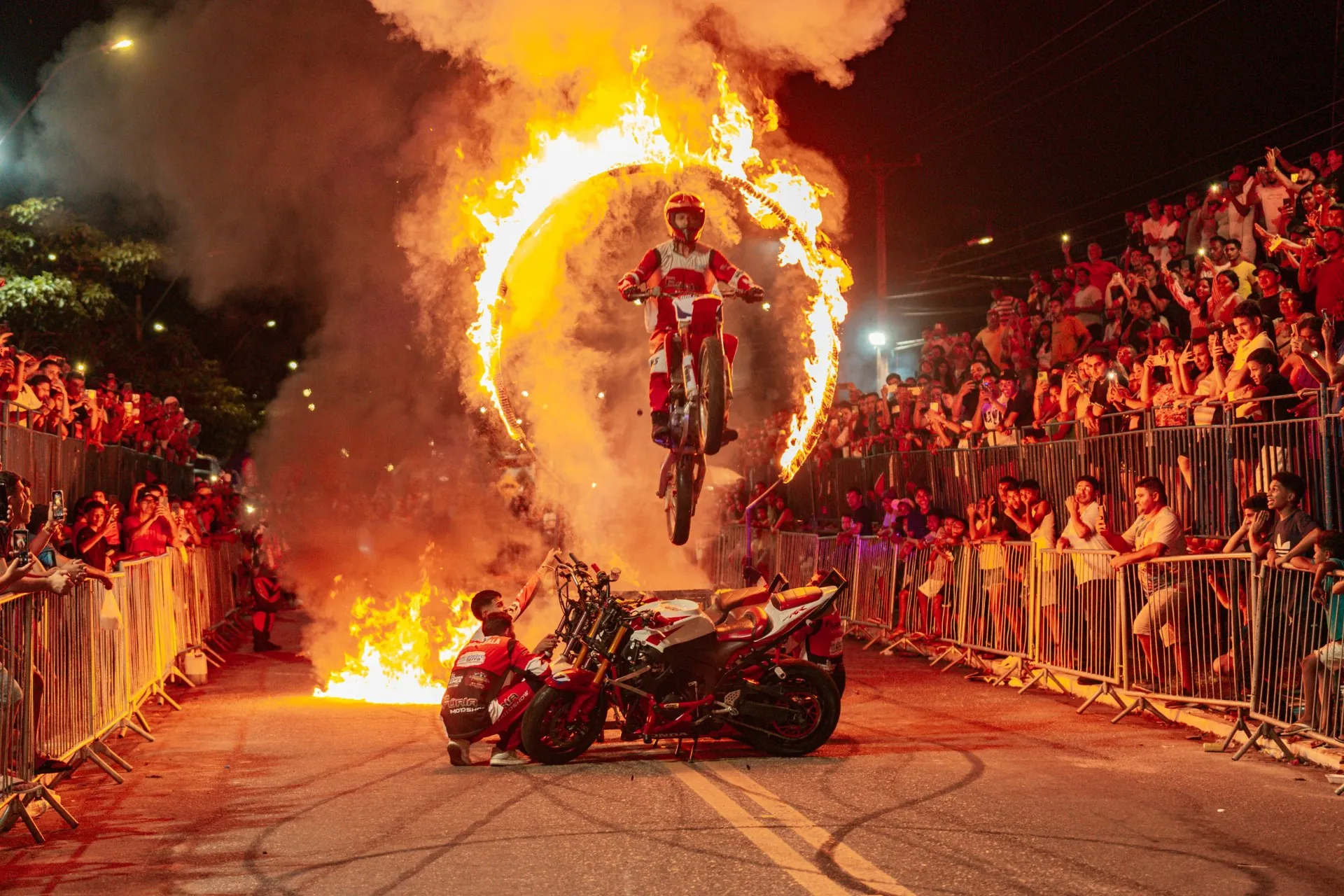 Stunt rider jumping through a ring of fire in the main arena