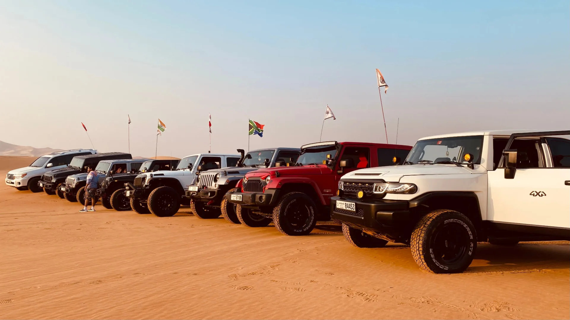 Line-up of 4x4 vehicles in the desert at MOC27