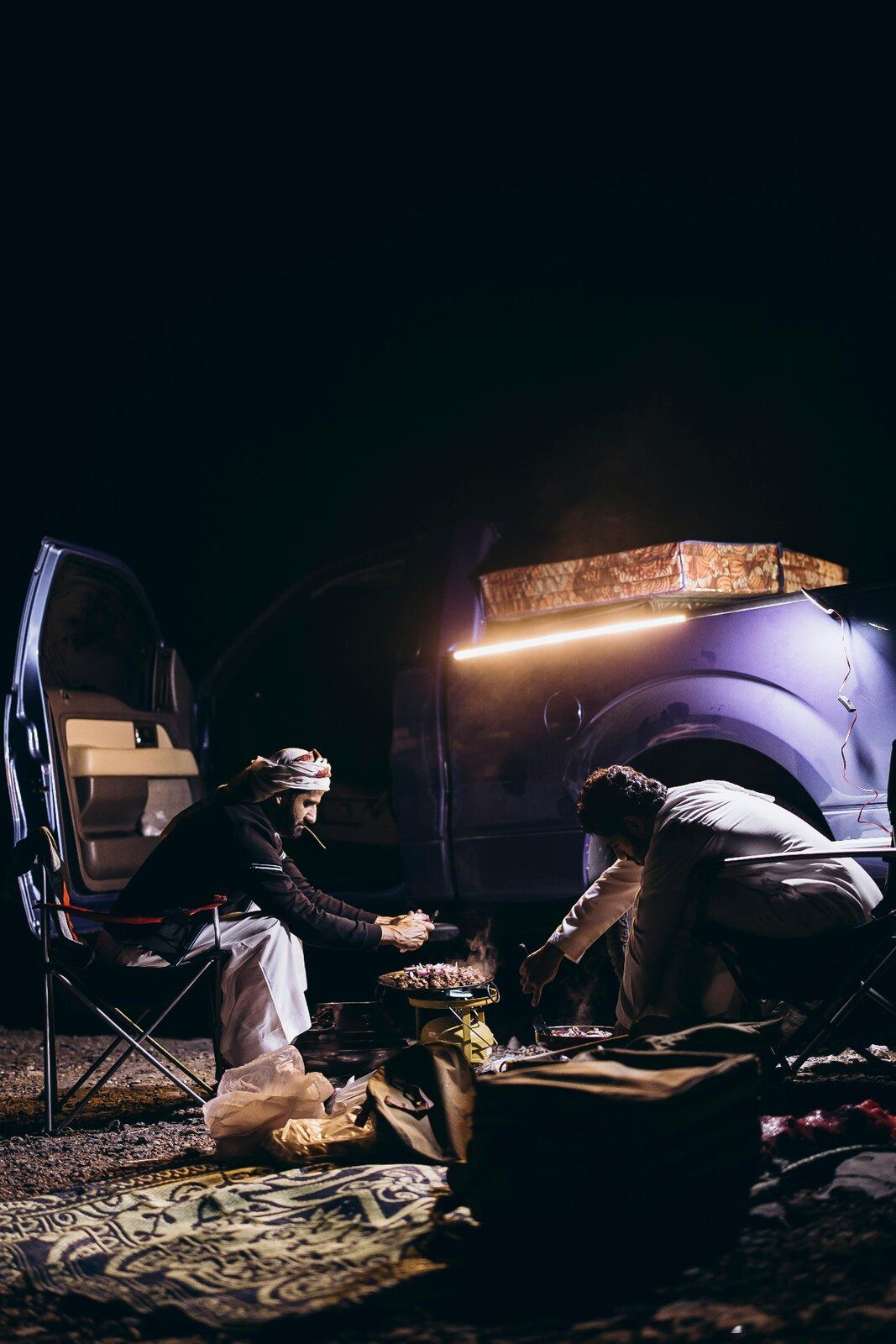 Open-fire camp cookout at night